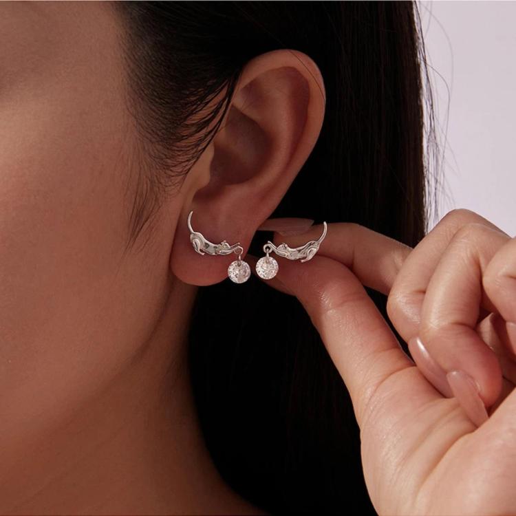 Dachshund charm earrings on ear, silver-tone with two round crystal drops