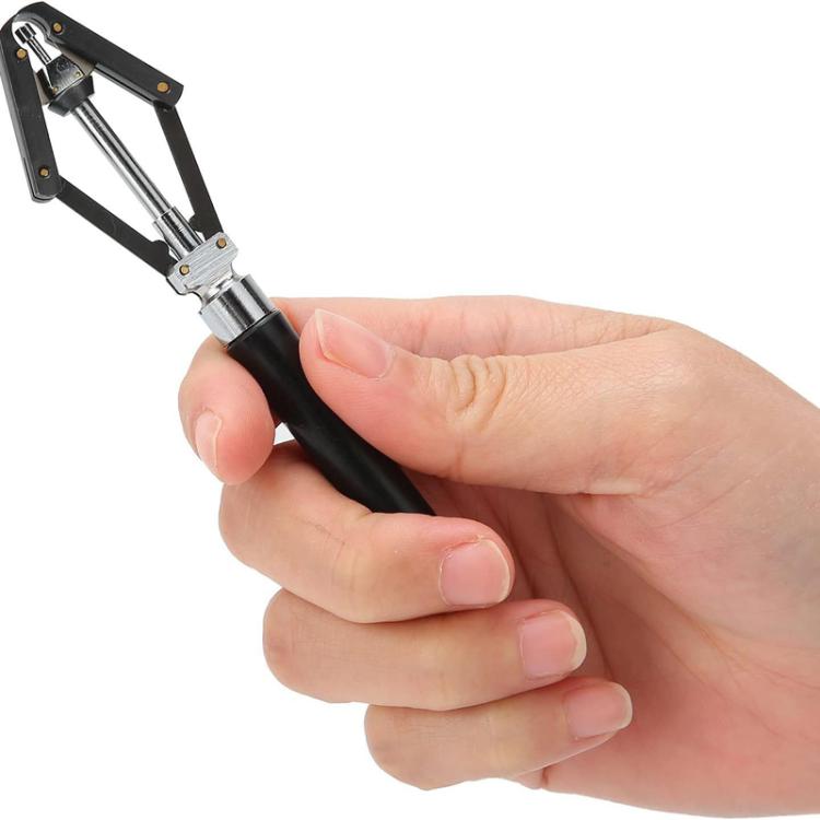 Watch needle remover tool with black handle and metal jaws, held in hand