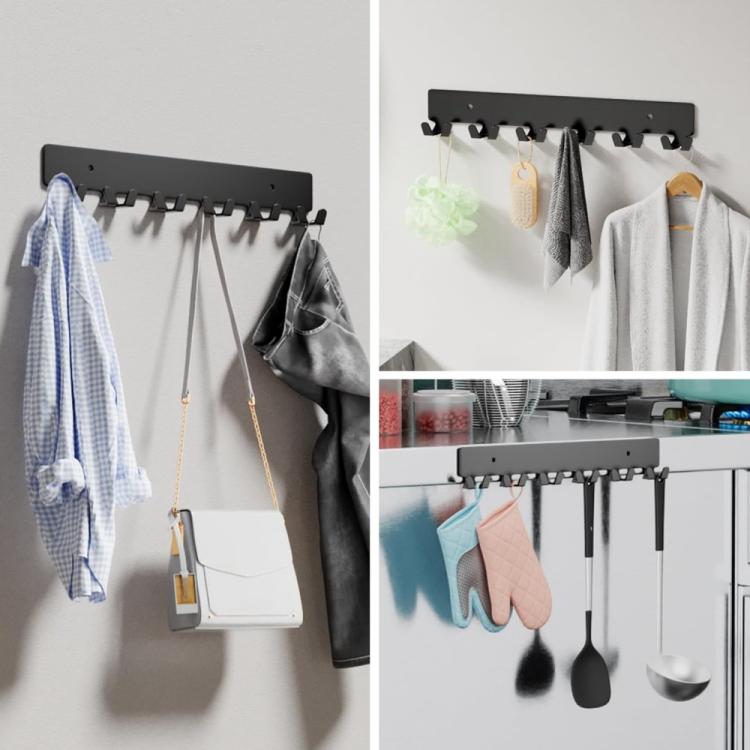 Black metal key wall hook rack with six hooks on wall, holding coats and keys
