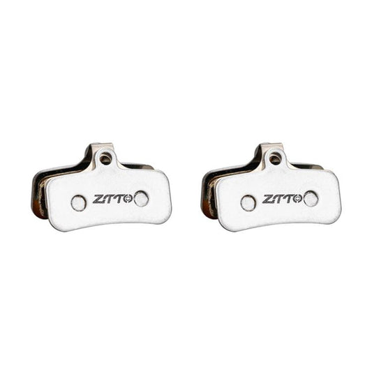 Two bicycle disc brake pads with metal backing and ZTTO marking, shown from the side