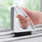 White triangular gap brush with black bristles for cleaning window frames
