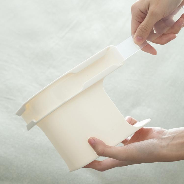 White sheet clip holder with locking tabs, gripped by hands