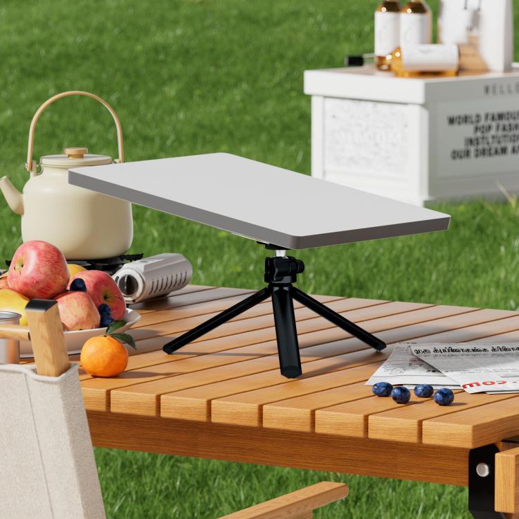 Black tripod with gimbal adapter on table, with wide white mounting plate