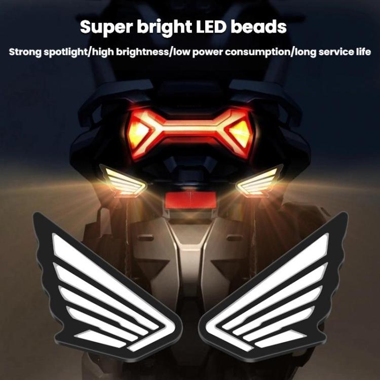 Pair of wing-shaped LED lights with white housing and bright red glow