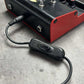 Inline DC key switch cable with black switch housing attached to a device power port