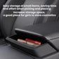 Installed armrest storage drawer holding small items, dark matte black