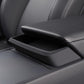 Center console armrest storage tray installed, dark matte black with open lid