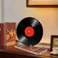 Clear acrylic record holder stand with circular black vinyl on base