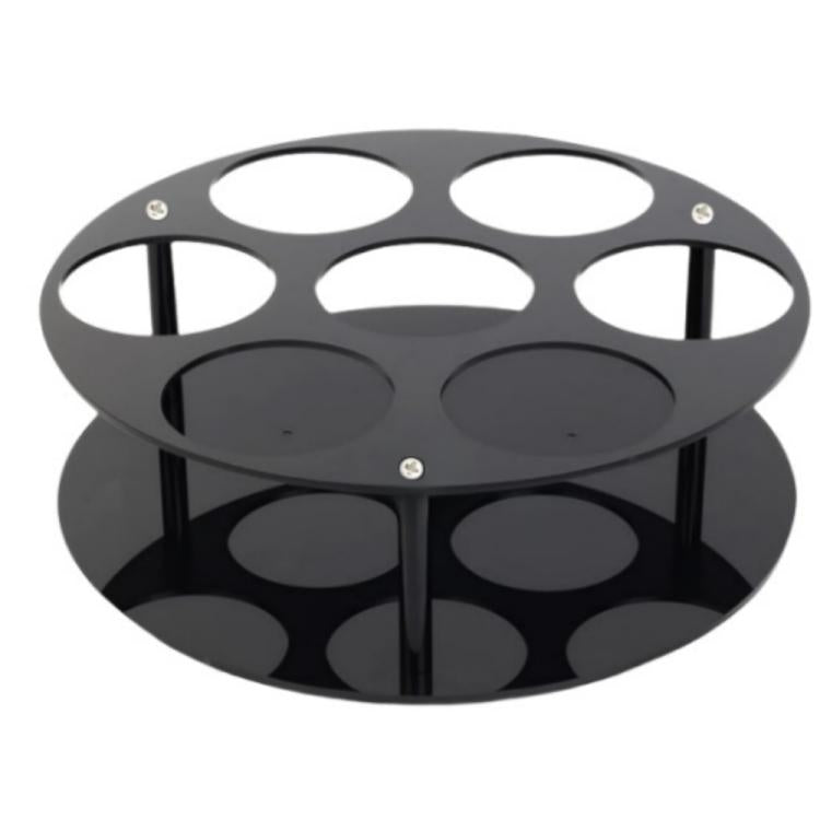 Black round acrylic bottle holder with circular cutouts and two-tier base
