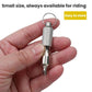 Valve core wrench with textured metal grip on a key ring, held in hand