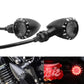 Black LED motorcycle turn signal lights with round lenses; one shows red illuminated light