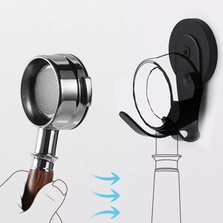 Black magnetic hook holding a metal coffee tool by its handle