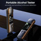 Portable breath alcohol tester in dark finish with lit screen and indicator bars