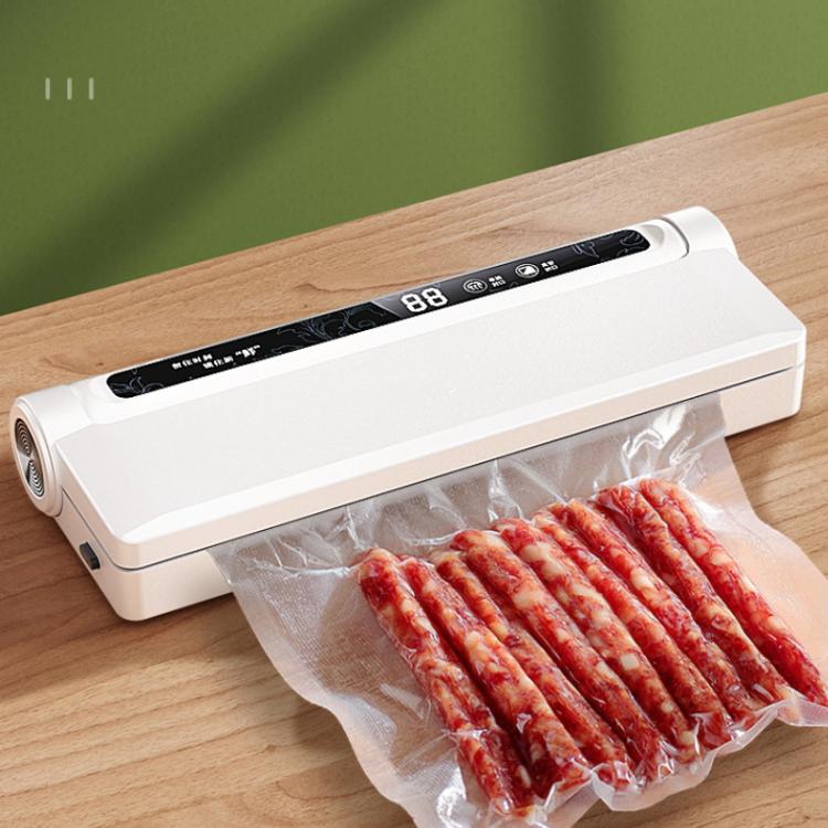White vacuum sealer sealing a clear bag of sliced meat on a wooden surface