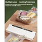 White vacuum packaging machine bagging food items on a tray with clear film