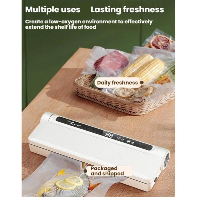 White vacuum packaging machine bagging food items on a tray with clear film