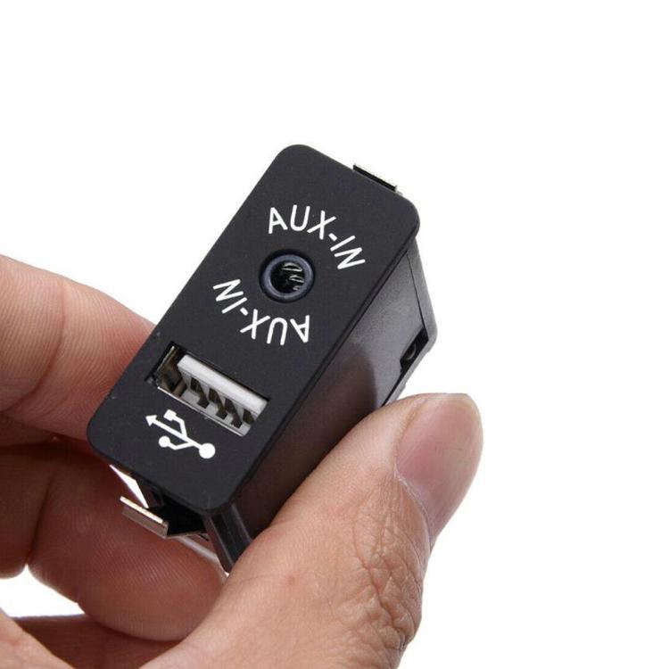 Black AUX-IN switch with USB icon and 3.5mm audio jack, held in hand