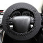Dark steering wheel cover with textured seam, fitted over wheel center