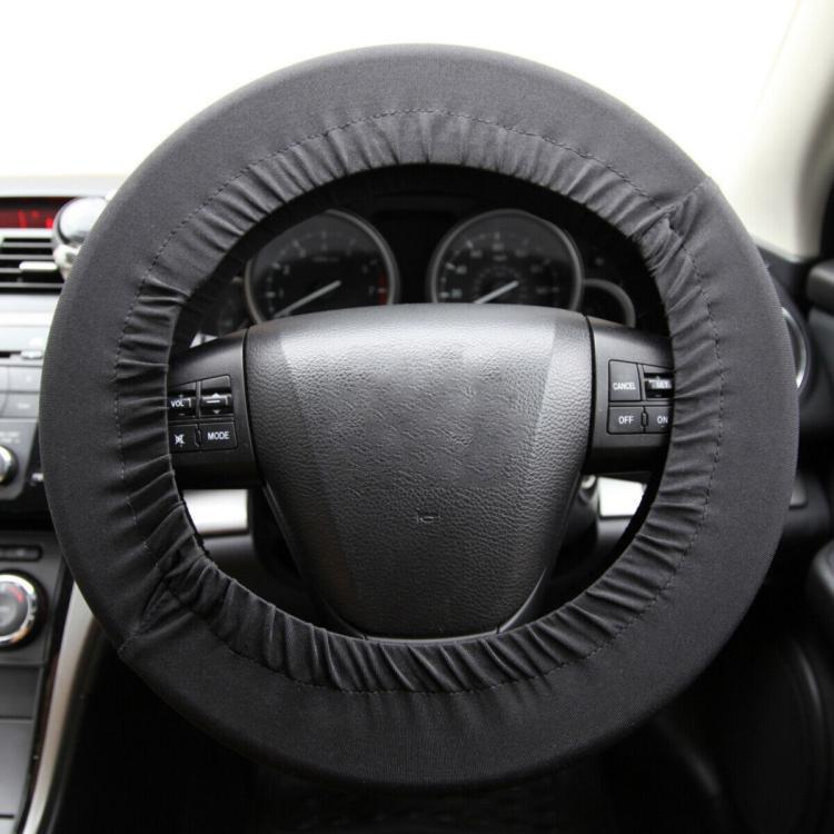 Dark steering wheel cover with textured seam, fitted over wheel center