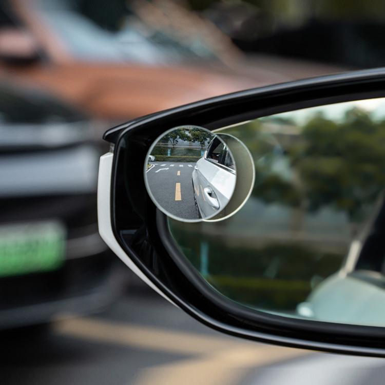 Small round frameless suction-cup mirror attached to a car side window, silver metal rim