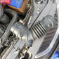 Air intake pipe assembly with corrugated hose and metal coupler in engine bay