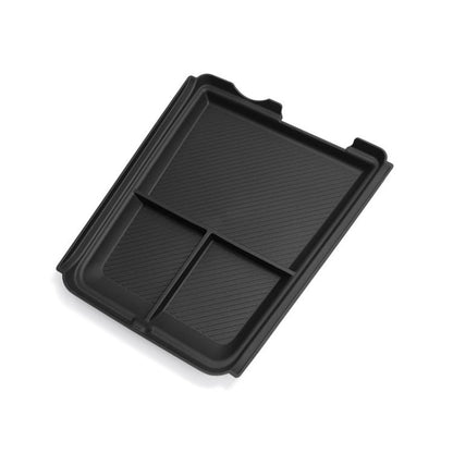 Black center console lower storage box with divided compartments and molded tray.