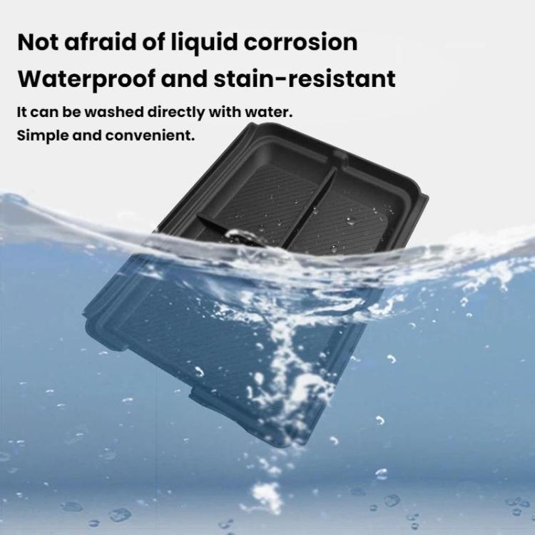 Black center console storage box insert with water droplets on stain-resistant surface.