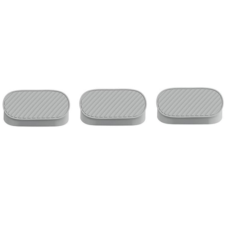 Gray silicone hole plug for passenger-side opening, oval with ribbed top texture