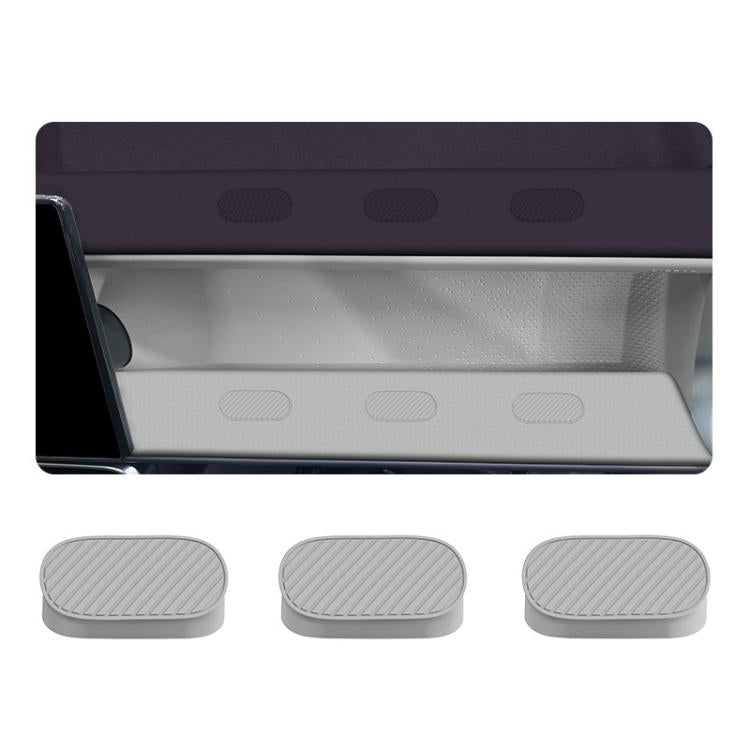 Set of gray oval silicone hole plugs with ribbed pattern, shown near vehicle panel