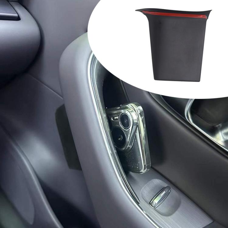 Car door armrest storage box installed, holding small items near center console