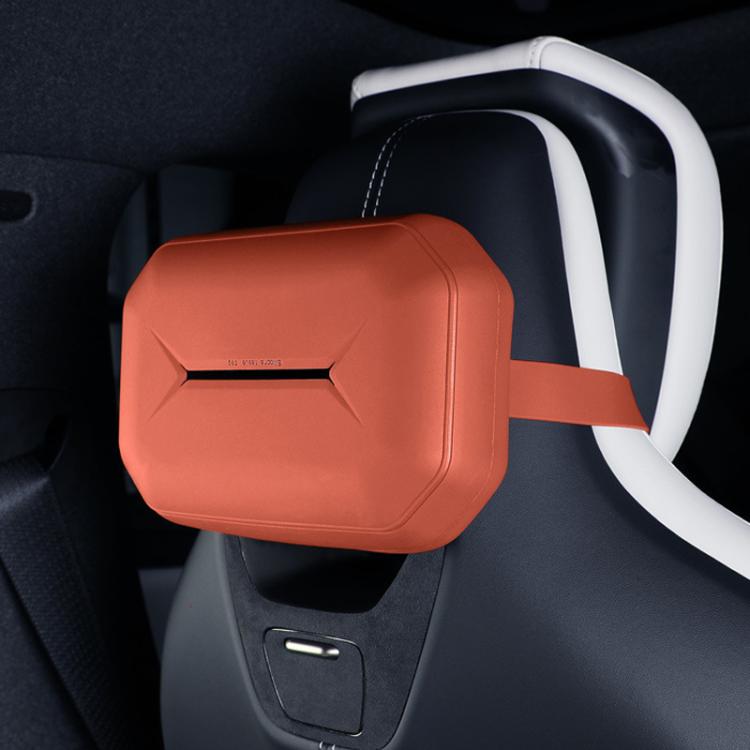Orange silicone hanging tissue box mounted on car seat with white strap