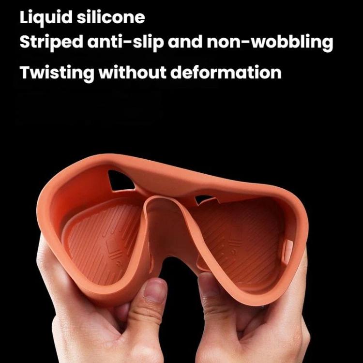 Orange silicone water bottle pad insert held by hands, textured interior surface