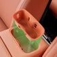 Orange silicone water bottle pad insert installed in front armrest storage area