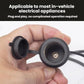 Black cigarette lighter extension cable ends, shown side-by-side in hand