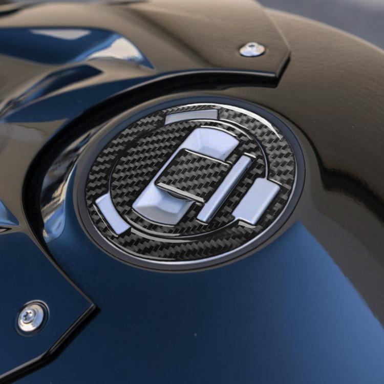 Round fuel tank cap sticker with black carbon-fiber pattern and chrome ring