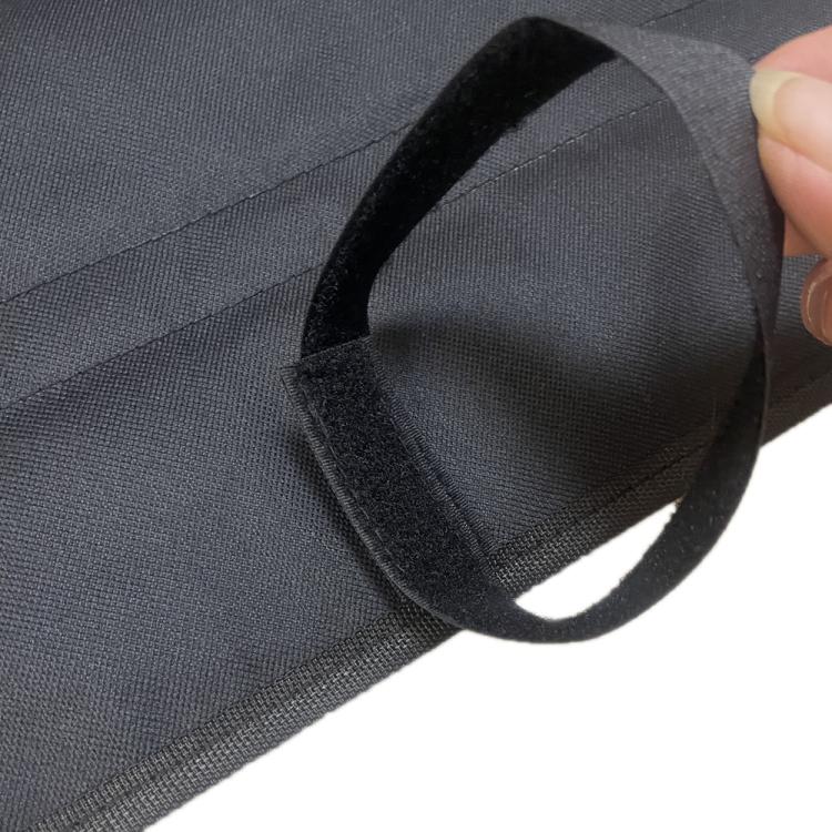 Close-up of foldable car bumper mat fabric with attached carrying tie
