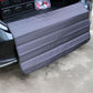 Foldable car trunk bumper protective mat in gray with stitched panels and grommet corners