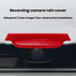 Red rear camera rain shield covering the rear camera lens area