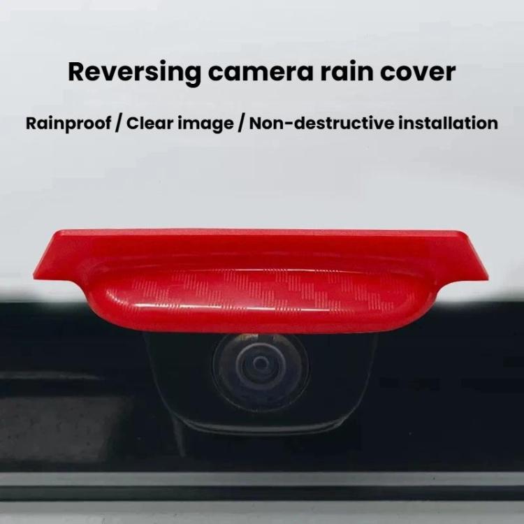 Red rear camera rain shield covering the rear camera lens area