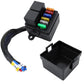 Black fuse box with relay, blade fuses, and open base cover