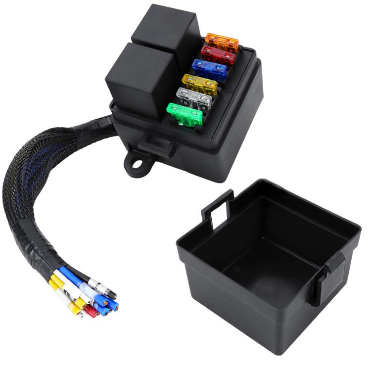 Black fuse box with relay, blade fuses, and open base cover