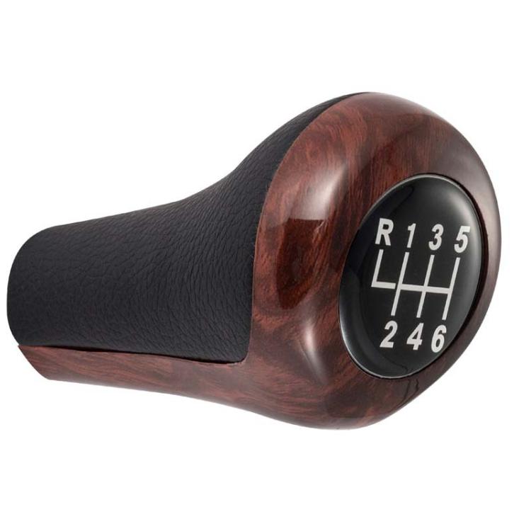 Dark brown wood-grain gear shift knob with black leather base and 6-speed dial