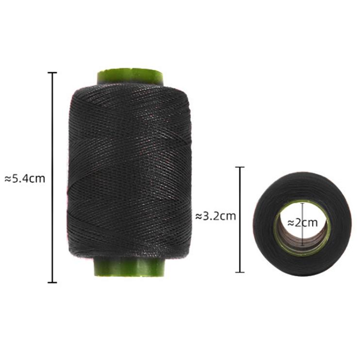 Black sewing thread spool with green core and small thread roll, size view