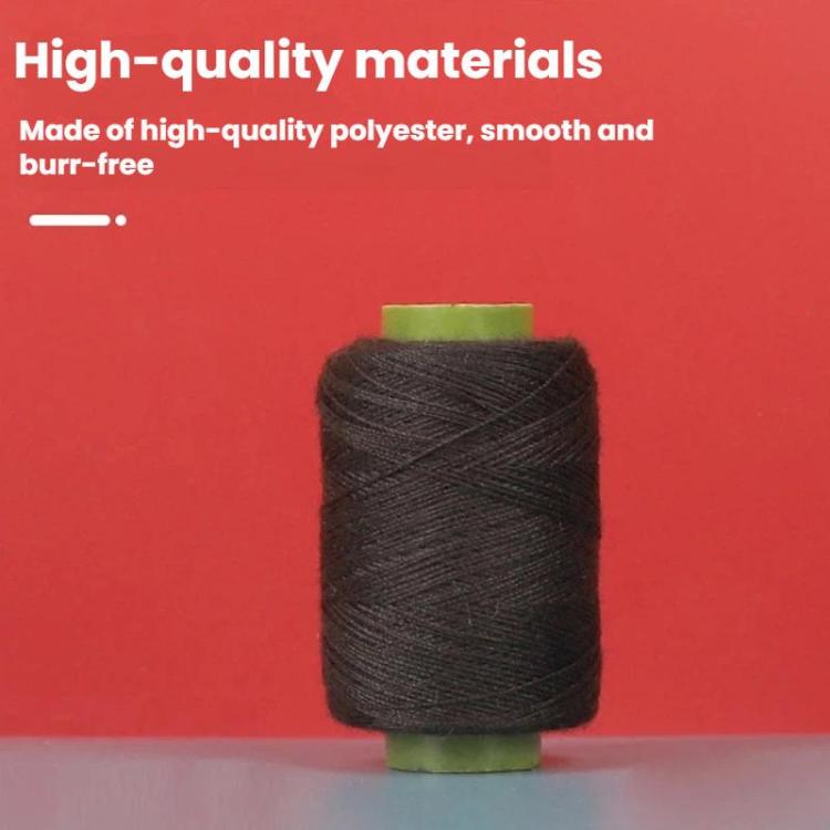 Black sewing thread spool on green core, close-up