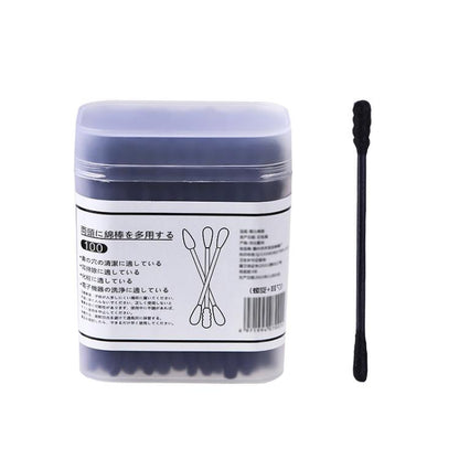 Disposable double-ended cotton swab, shown with a single black swab beside box pack