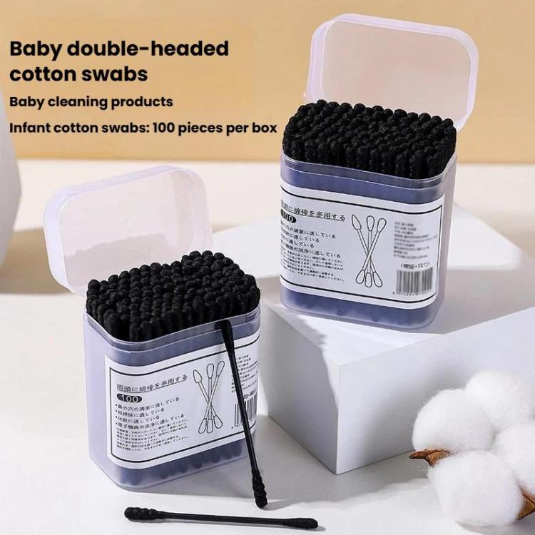 Box of black disposable cotton swabs with spiral tips, plus a loose swab