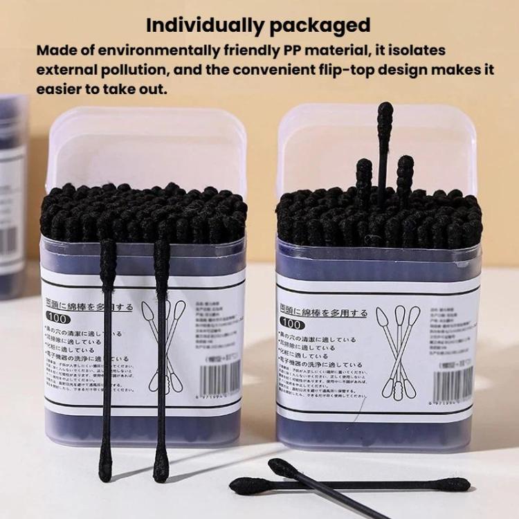 Two boxes of disposable cotton swabs with black spiral tips and loose swab
