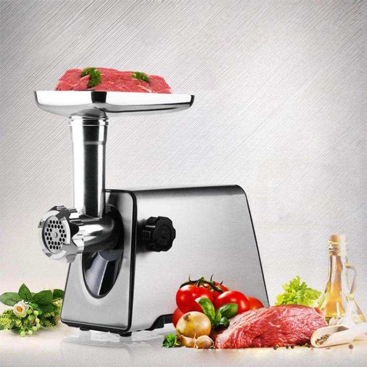 Electric meat grinder on a countertop with stainless steel body and feed tube