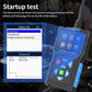 Black OBD2 scanner displaying startup test menu with blue button controls