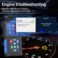 OBD-II car diagnostic scanner with blue keypad beside dashboard engine warning light